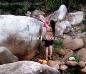 A girl change clothes inside the waterfall